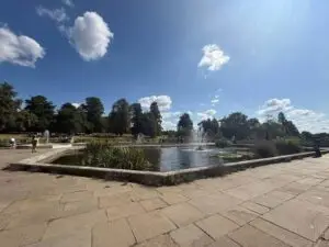 Ornate fountains are in the middle of fish ponds.