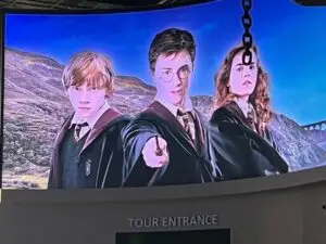 Neon pink lighting welcomes visitors to the Harry Potter experience.